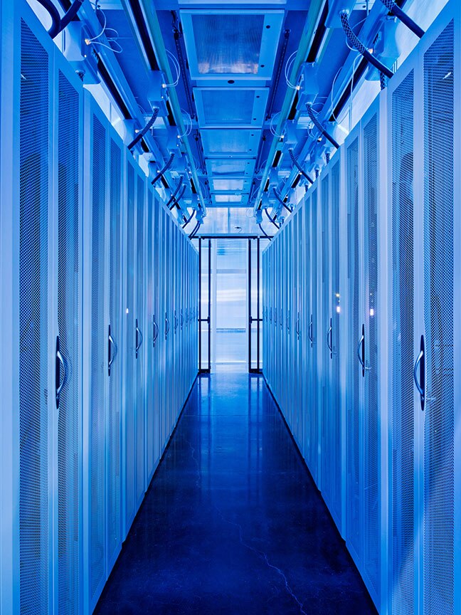 Inside server room, with many rows of ervers