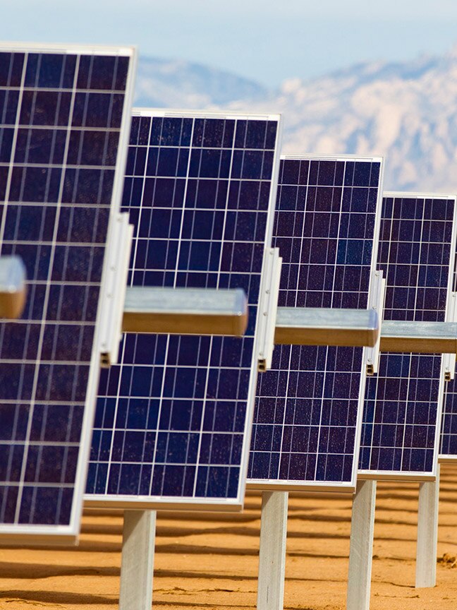 Solar panels in a row stretching back as far as the eye can see