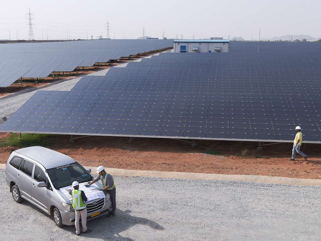 Car parked in front of solar pannels